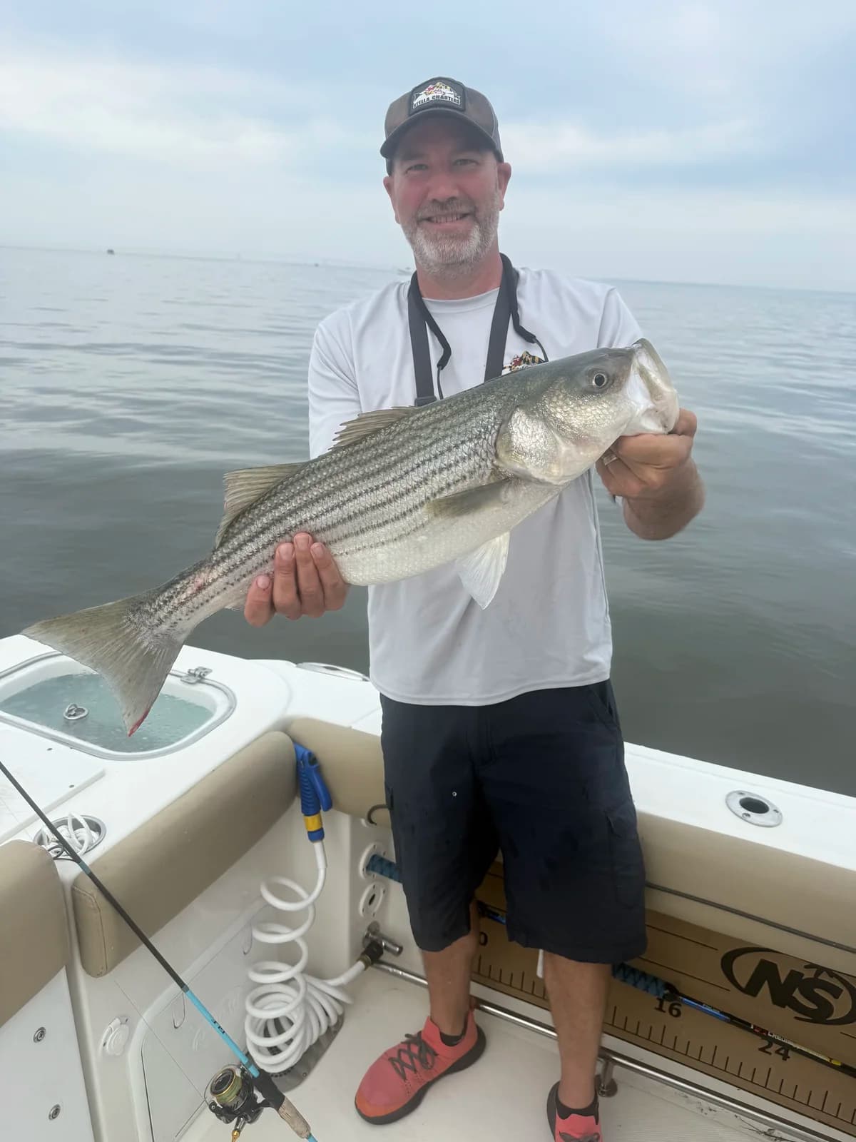 Captain Eric Goodrich, USCG licensed fishing guide, with a trophy striped bass